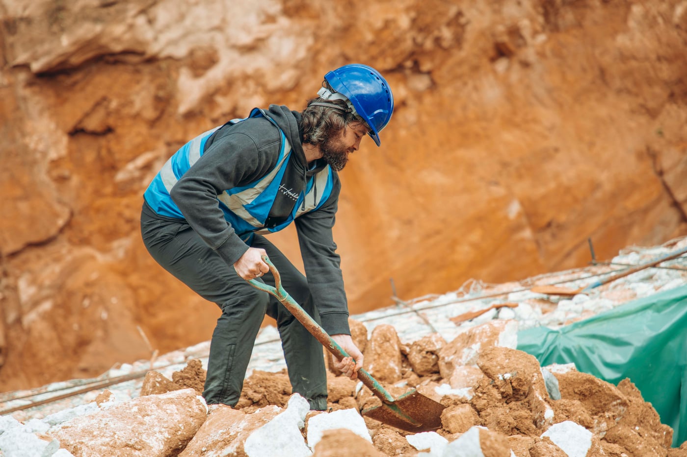 Lambert Vissot digging gem-bearing ground in an open pit