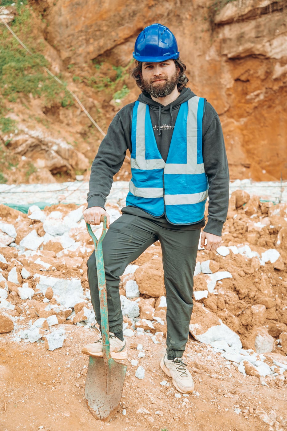 Lambert Vissot standing in a working gem pit with a shovel