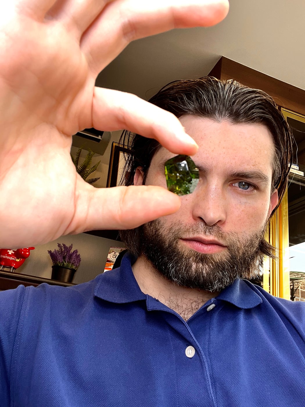 Lambert Vissot holding green rough up to the light