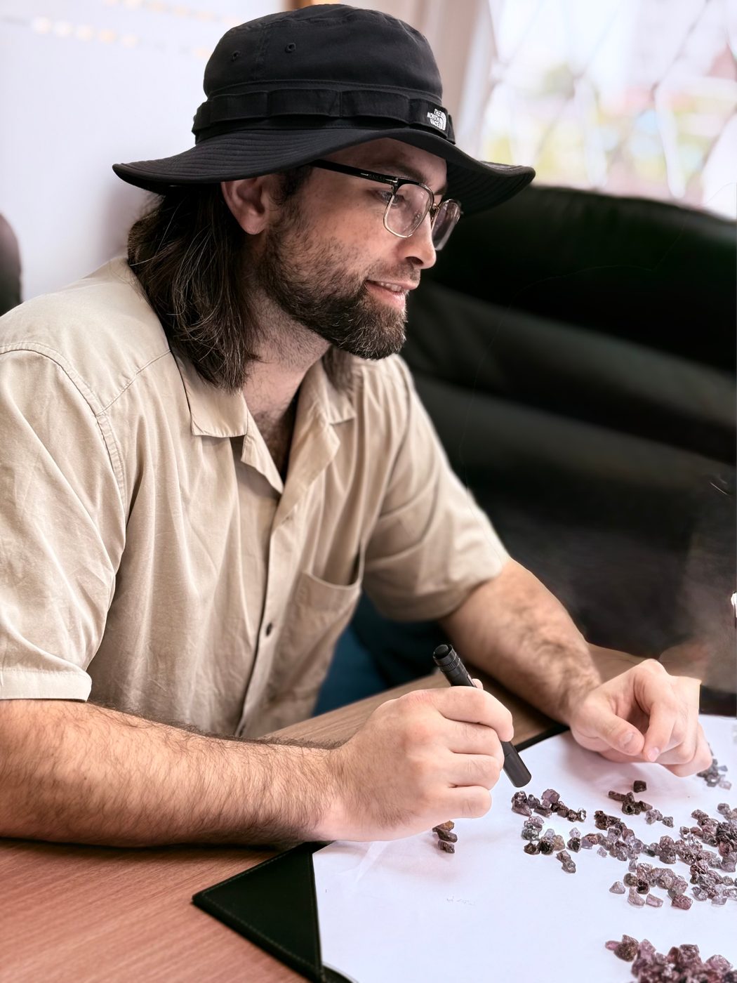 Lambert Vissot sorting rough stones at the desk