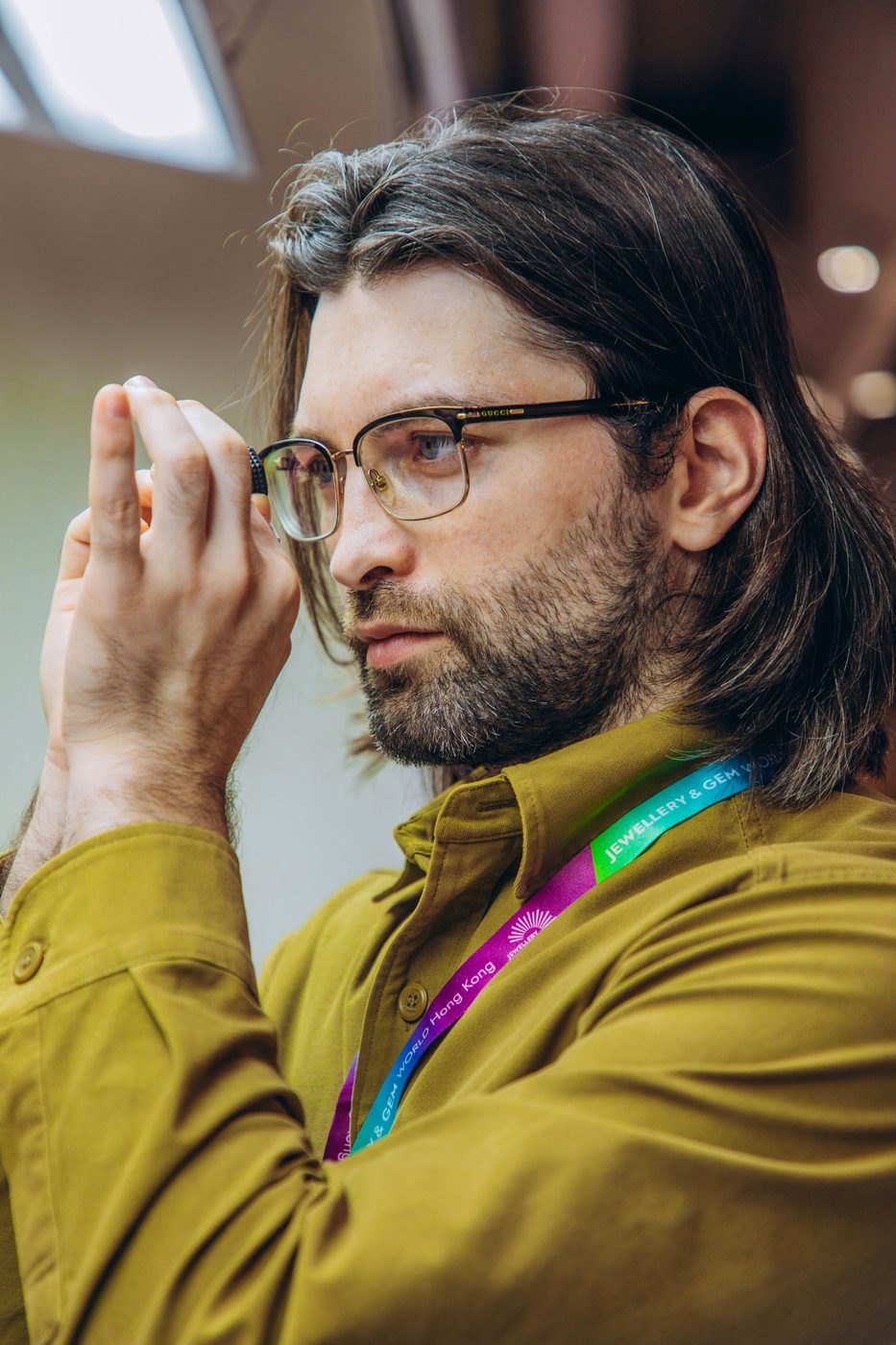 Lambert Vissot lifting his glasses to examine a stone