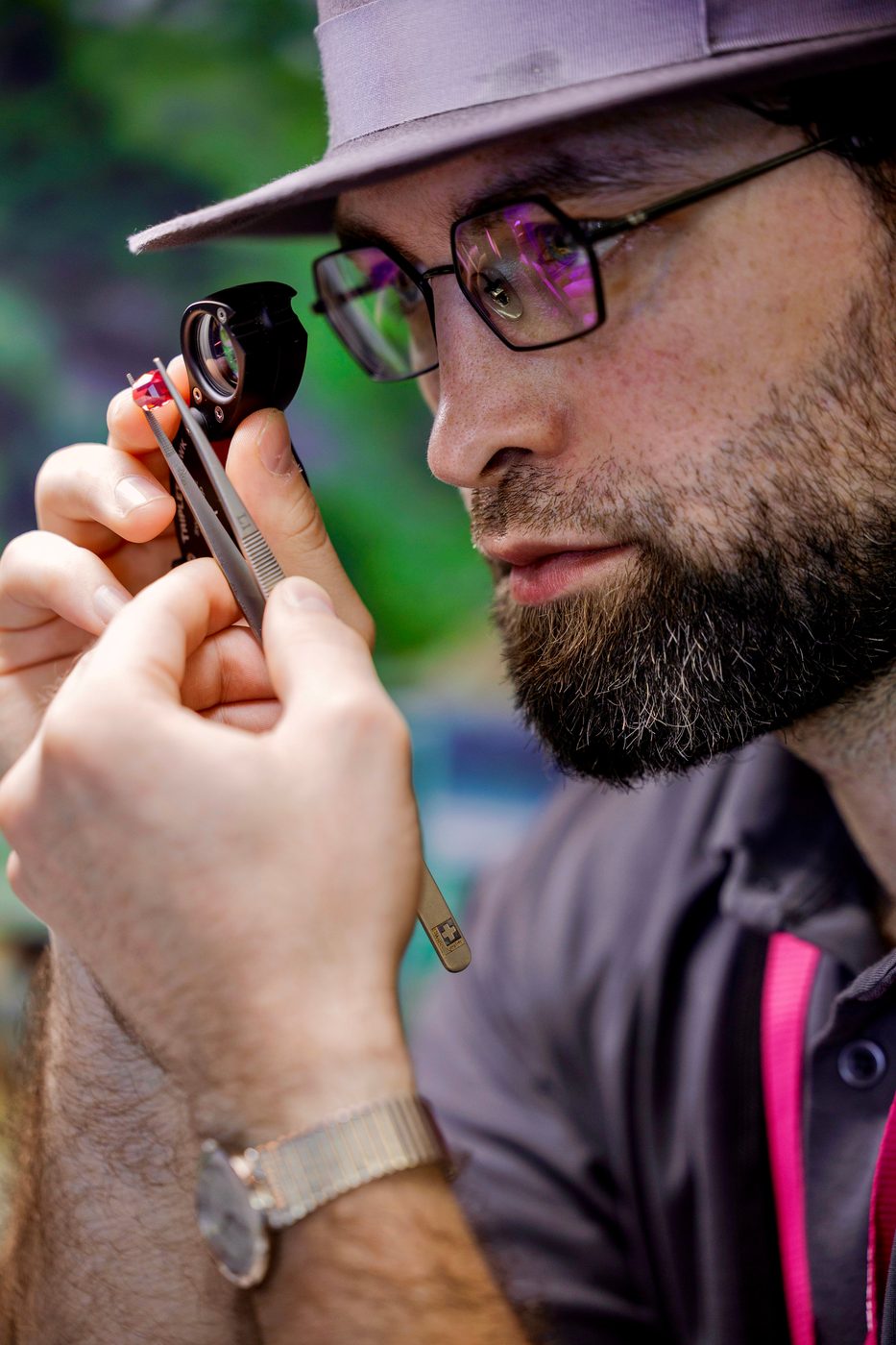 Close inspection of a stone with a ten-power loupe