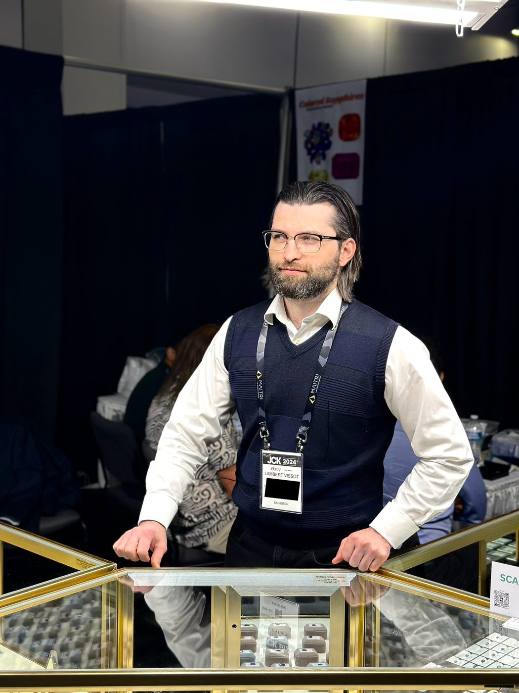 Lambert Vissot behind a display case at a gem fair